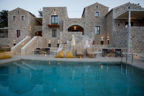 a house with a swimming pool in front of a building at ERMIS-APEA Villas in Limeni