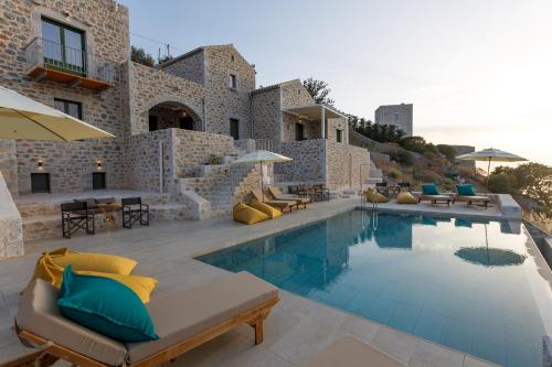 a villa with a swimming pool in front of a building at ERMIS-APEA Villas in Limeni