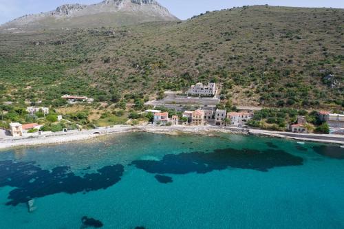 an aerial view of a large pool of blue water at ERMIS-APEA Villas in Limeni