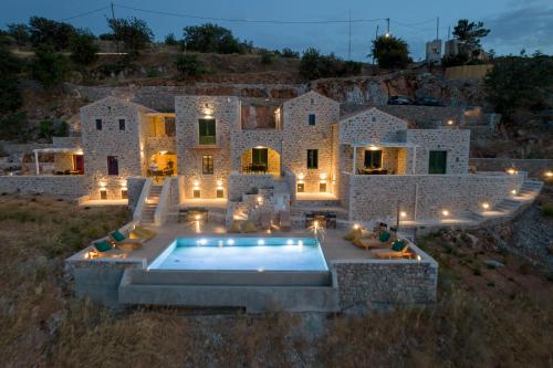 a large stone house with a pool in front of it at ARIS-APEA Villas in Limeni
