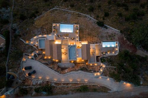 an aerial view of a building at night with lights at ARIS-APEA Villas in Limeni