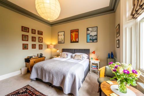 a bedroom with a bed and a table at Washington House in Nairn
