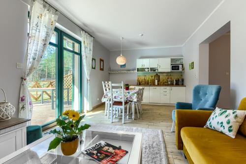 a living room with a couch and a table at Rentynówka in Gietrzwałd