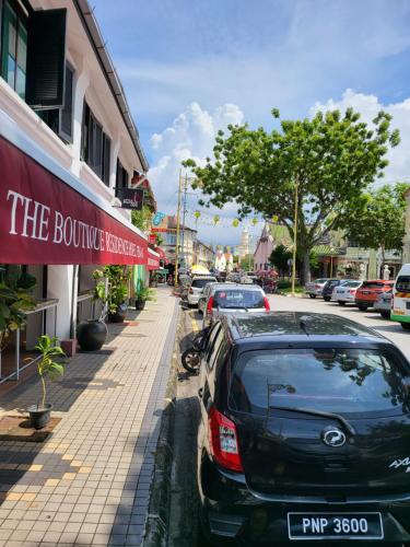 a row of cars parked on the side of a street at The Boutique Residence Hotel in George Town