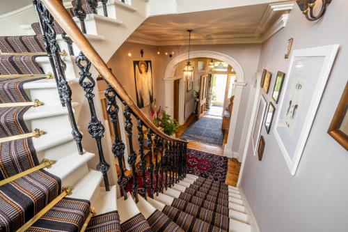 a staircase in a home with a stair case at Washington House in Nairn