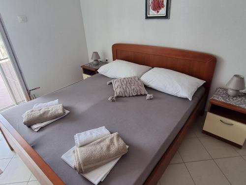 a bed with two pillows on top of it at Mima in Sveti Juraj
