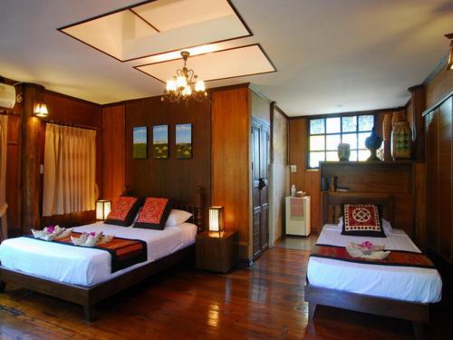 Säng eller sängar i ett rum på Baantawan Guesthouse Pai