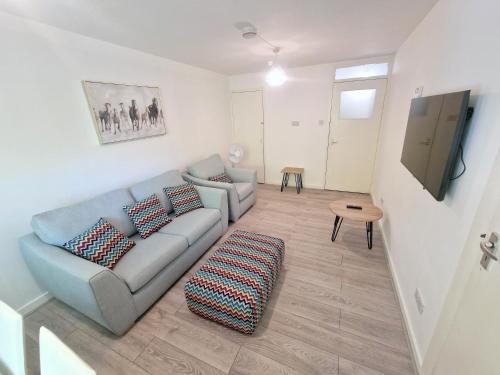 a living room with a couch and a table at Flat in Battersea, 5 minutes from Clapham Junction Station in London