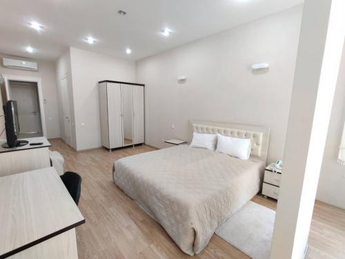 a bedroom with a bed and a television in it at Chukhur Gabala Museum Hotel in Gabala