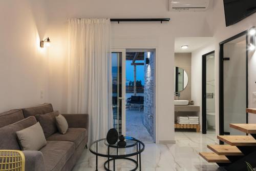 a living room with a couch and a glass table at Solis Villa, with Heated Pool & 5 minutes to Beach, By ThinkVilla in Kavros