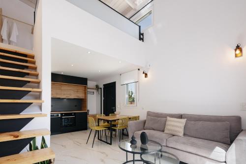 a living room with a couch and a table at Solis Villa, with Heated Pool & 5 minutes to Beach, By ThinkVilla in Kavros