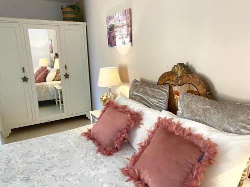 a bedroom with a bed with pillows and a mirror at Casa Doramas VV in Las Palmas de Gran Canaria