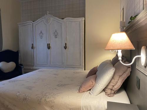 a bedroom with a white bed with a lamp at Casa Doramas VV in Las Palmas de Gran Canaria