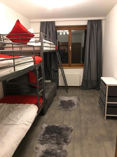 a dorm room with two bunk beds and a window at Ski and Lake View Apartment in Zell am See