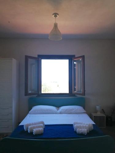 a bedroom with a bed with two pillows on it at Open Space a due passi dal mare in Ustica