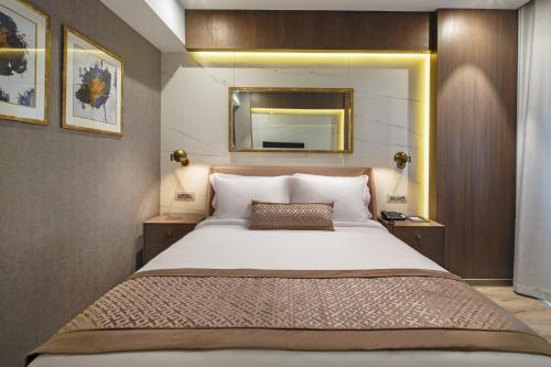a bedroom with a large bed and a mirror at Mula Hotel in Istanbul