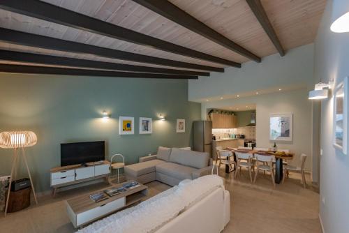 a living room with a couch and a table at Linas Home - Kalamata Mediterranean Villas in Kalamata