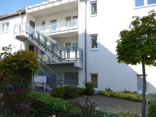 ein weißes Gebäude mit einer Treppe davor in der Unterkunft Ferienwohnung "Am Seeufer 1" Objekt ID 1205 in Waren (Müritz)
