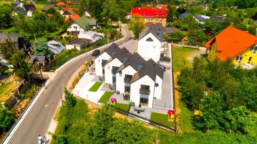an overhead view of a village with a house and a road at Domki Sikorskiego II, Sun & Snow in Karpacz