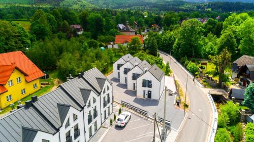 an aerial view of a town with houses and a road at Domki Sikorskiego II, Sun & Snow in Karpacz