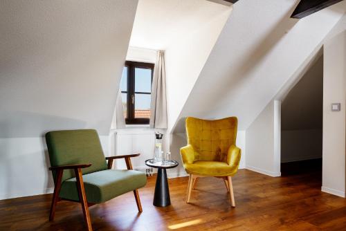 a living room with two chairs and a table at Hotel Waren-Alte Warener Zeitung in Waren