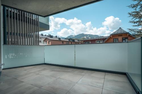 a balcony with a white fence with a view at Das Conrad by Schladming-Appartements in Schladming