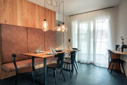 a dining room with a table and chairs with laptops on it at Das Conrad by Schladming-Appartements in Schladming