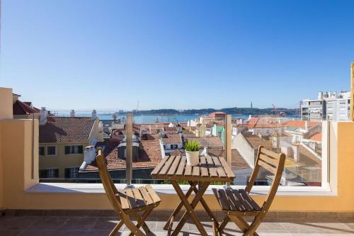 a table and chairs on a balcony with a view at Designer Flats in Lapa by LovelyStay in Lisbon