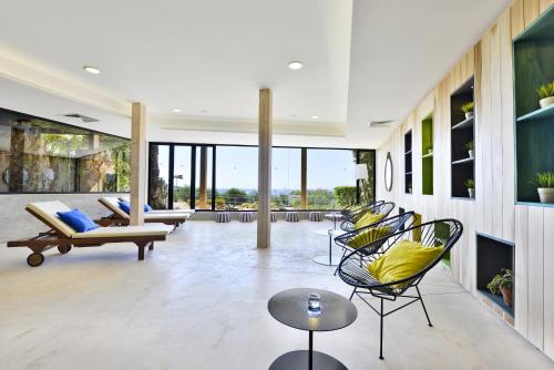 a living room with chairs and a fireplace at Napa Mermaid Hotel & Suites in Ayia Napa