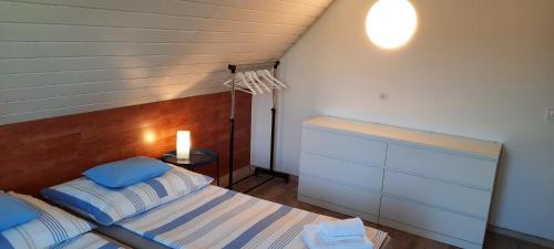 a bedroom with a bed with blue and white pillows at Kati Villa in Vonyarcvashegy