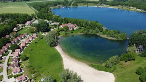an aerial view of a lake and houses at Vakantiepark 't Broeckhuys in Ewijk