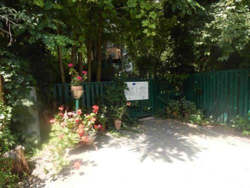 a blue fence with flowers and a sign on it at Robinson Crusoe in Lagodekhi