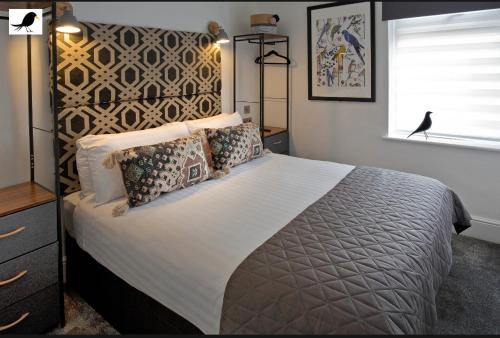 a bedroom with a large bed and a window at Blackbird Accommodation and Luxury Apartments room 14 in Blackpool