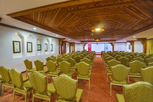a room with rows of chairs and a ceiling at Yucelen Hotel in Akyaka
