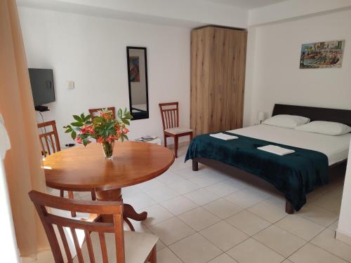 a room with a bed and a table and a bed and a table and chairs at Studio Apartman Radimir in Kotor