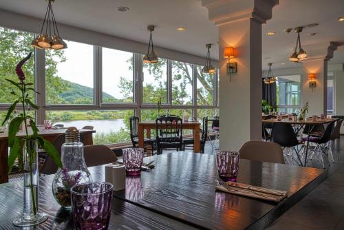 a dining room with a table with glasses on it at FourSide Plaza Hotel Trier, Trademark Collection by Wyndham in Trier