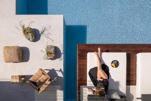 a woman is doing a yoga pose on a bed at Borosso Villa, an Exclusive Resort, By ThinkVilla in Skaleta