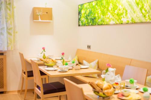 a dining room with a table with food on it at Haus Bergblick in Fuschl am See