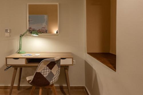 a desk with a lamp and a chair in a room at Linas Home - Kalamata Mediterranean Villas in Kalamata