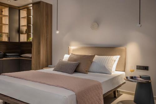 a bedroom with a bed with white sheets and pillows at SEA ZANTE Luxury Beachfront Retreat in Tragaki