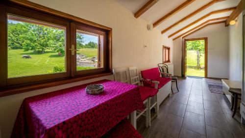 uma sala de jantar com uma mesa e uma janela em Kuća za odmor Feniks 3 em Ravna Gora