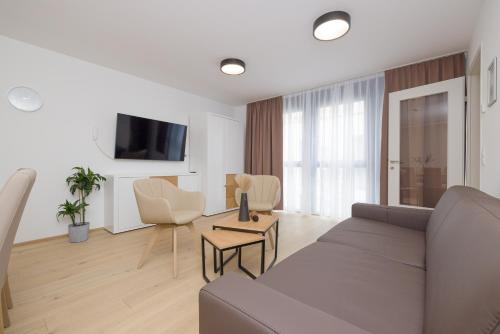 TV a/nebo společenská místnost v ubytování Yourapartment Theresien