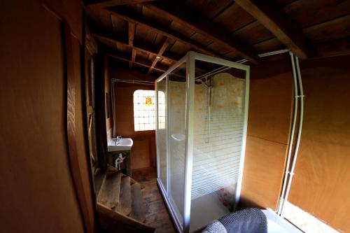 a bathroom with a shower and a sink at Yurt luxury + Bathhouse in Callington