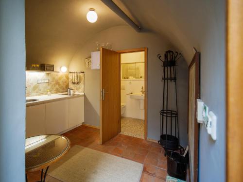 a kitchen with a door open to a bathroom at Romantic nest under Prague Castle in Prague