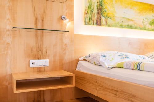 a bedroom with a bed and a painting on the wall at Haus Bergblick in Fuschl am See