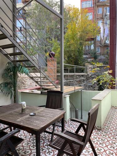 a patio with a wooden table and chairs on a balcony at Bosphorus Bridge in Istanbul