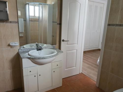 a bathroom with a sink and a mirror at APARTAMENTO NATURISTA in Playas de Vera