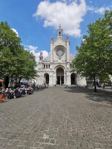 a large white building with a clock tower at Exclusive two-level apartment with private terrace on the canal Brussels in Brussels