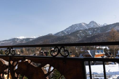 a view from a balcony with mountains in the background at Aparthotel Delta Royal in Kościelisko