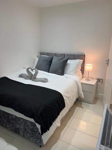 a bedroom with a large bed with two towels on it at Lovely holiday home in Southminster in Southminster
